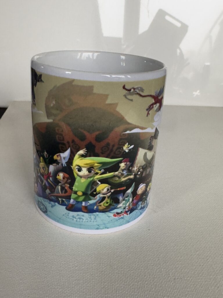 Why Choose Our Customised Zelda Mug Services Unique Designs: Personalise your mugs with iconic Zelda imagery, characters, and symbols, making each mug a true reflection of your love for the game. Premium Quality: Our mugs are made from durable, high-quality ceramic and printed with vibrant, long-lasting colors to ensure your designs stand out. Variety of Options: Choose from different sizes and styles, including standard, large, or travel mugs, to fit your preferences. Easy Ordering: Our user-friendly online platform allows you to effortlessly design and order your custom Zelda mugs in just a few steps. • Fast Turnaround: Enjoy quick and reliable service with mugs that are printed and delivered promptly, perfect for gifts or personal use.